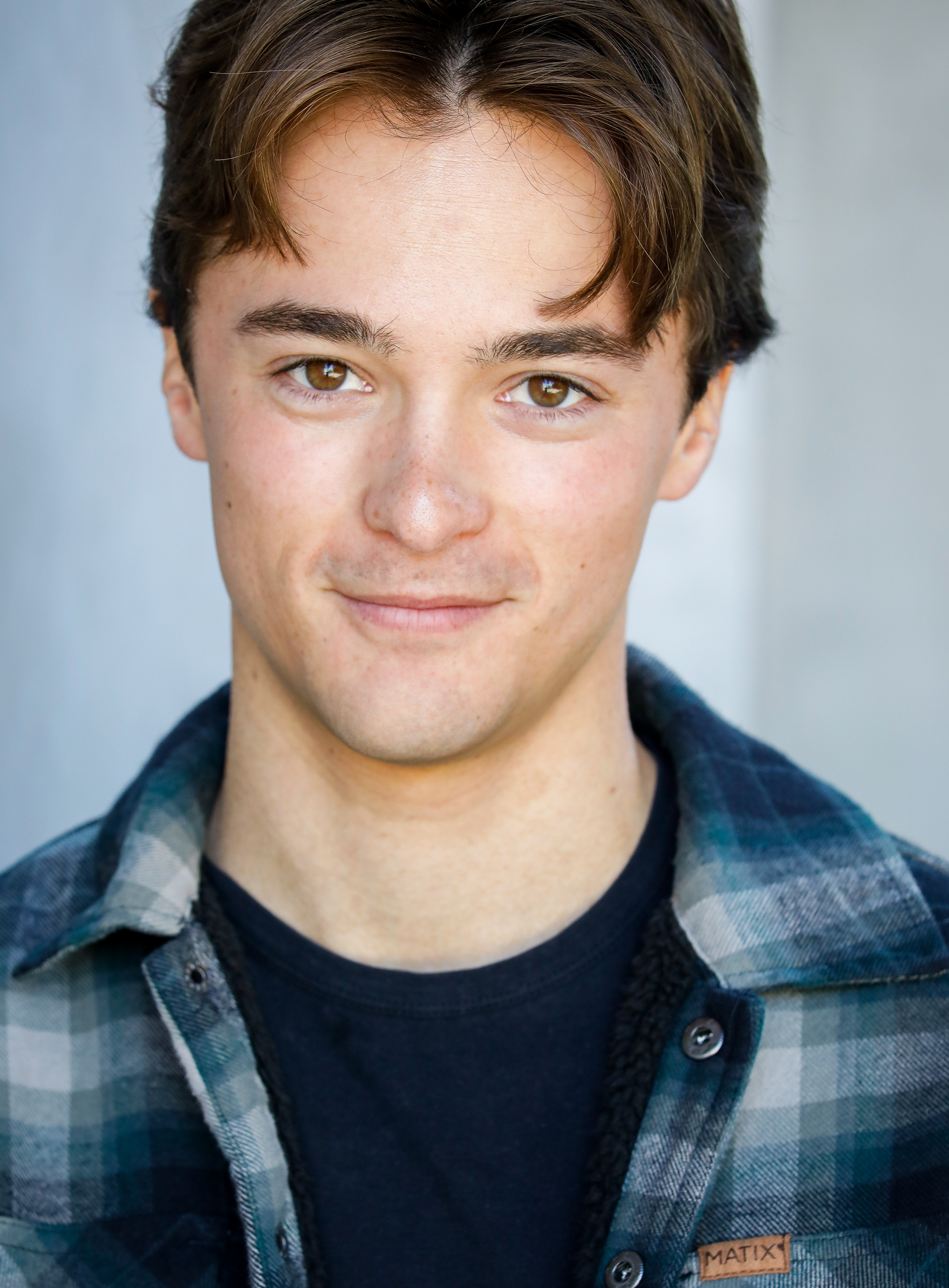 Leonardo Cecchi headshot in plaid shirt