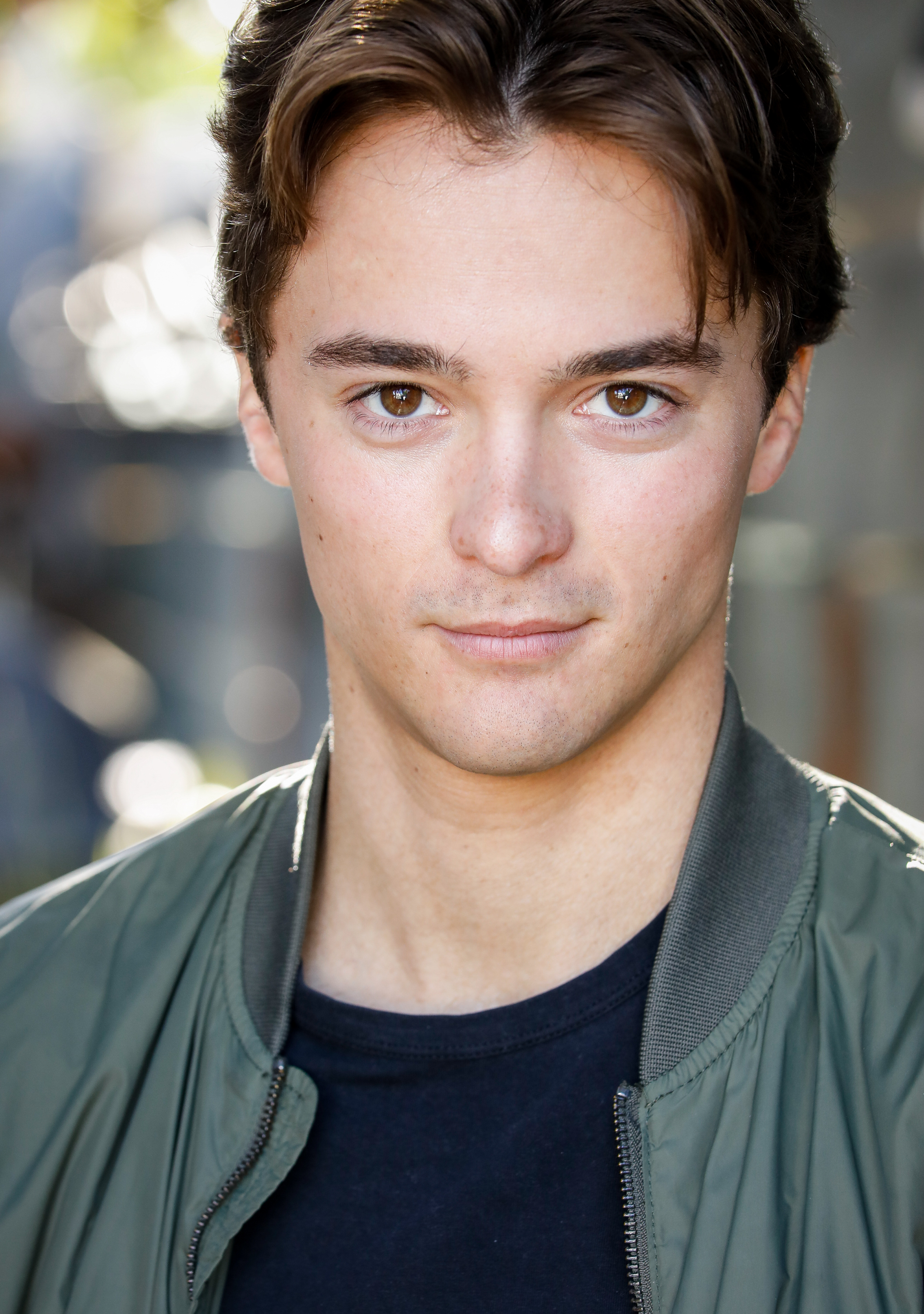 Leonardo Cecchi headshot in green bomber jacket
